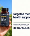 Hand holding an EvoHim bottle outdoors, original formula, 30 capsules